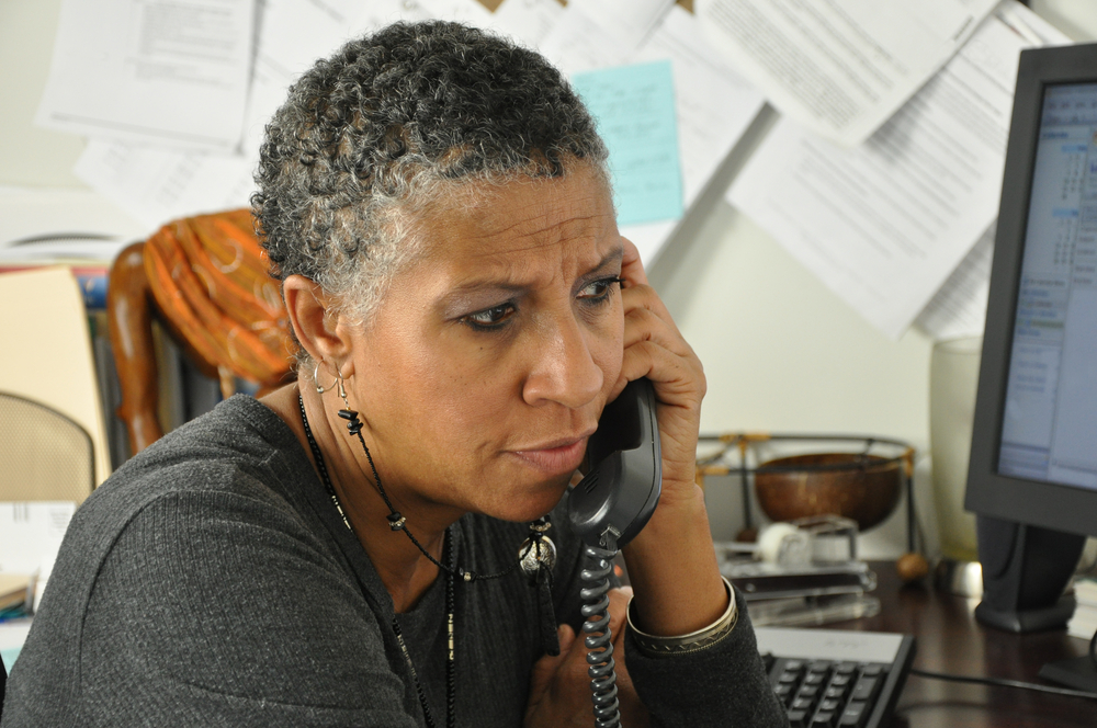 African American Professional Woman Listening on Phone Serious Facial Expression