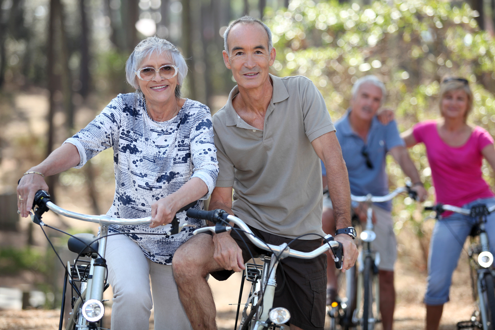 A mature couple on a double date bike riding.