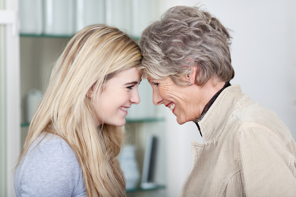 Side view of a happy young woman and mother or grandmother looking at each other.