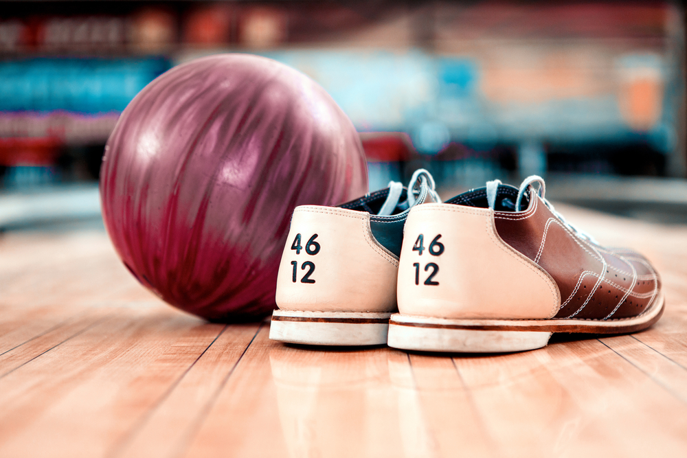 A bowling ball and bowling shoes.