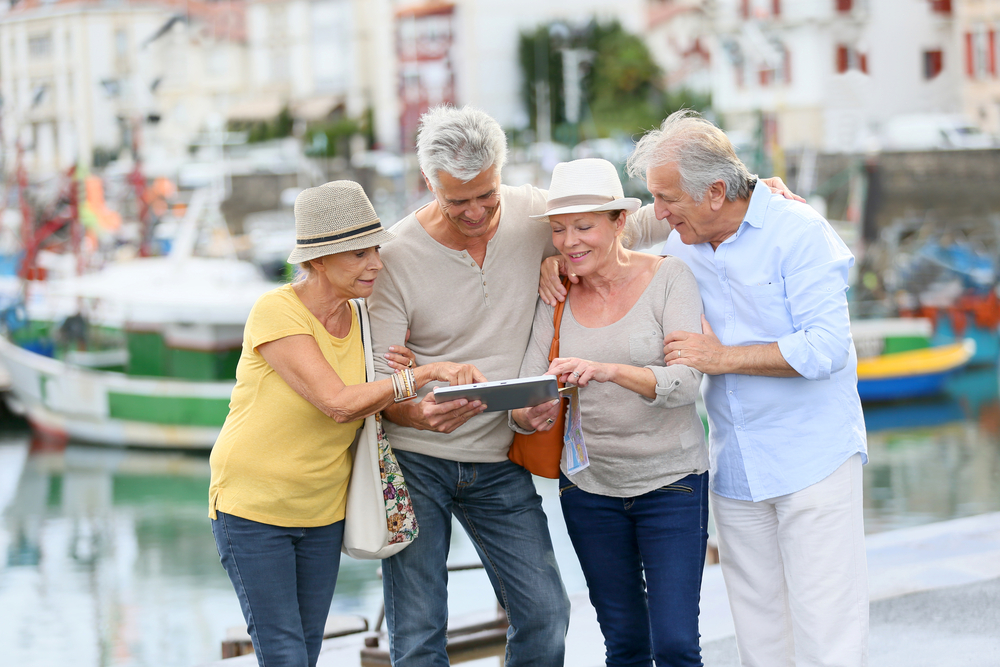 Senior couples looking at map on travelling journey
