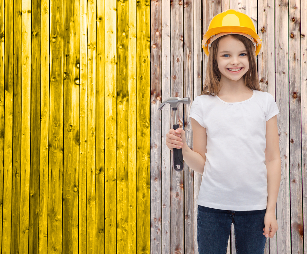 Young girl in hard hat construction theme.