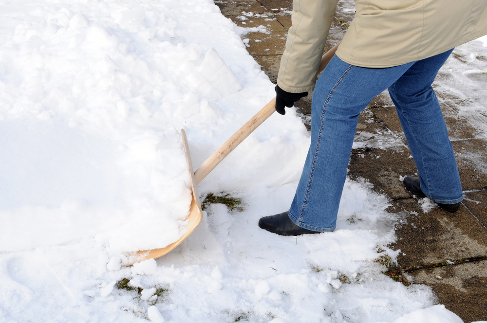 Woman is shovelling snow
