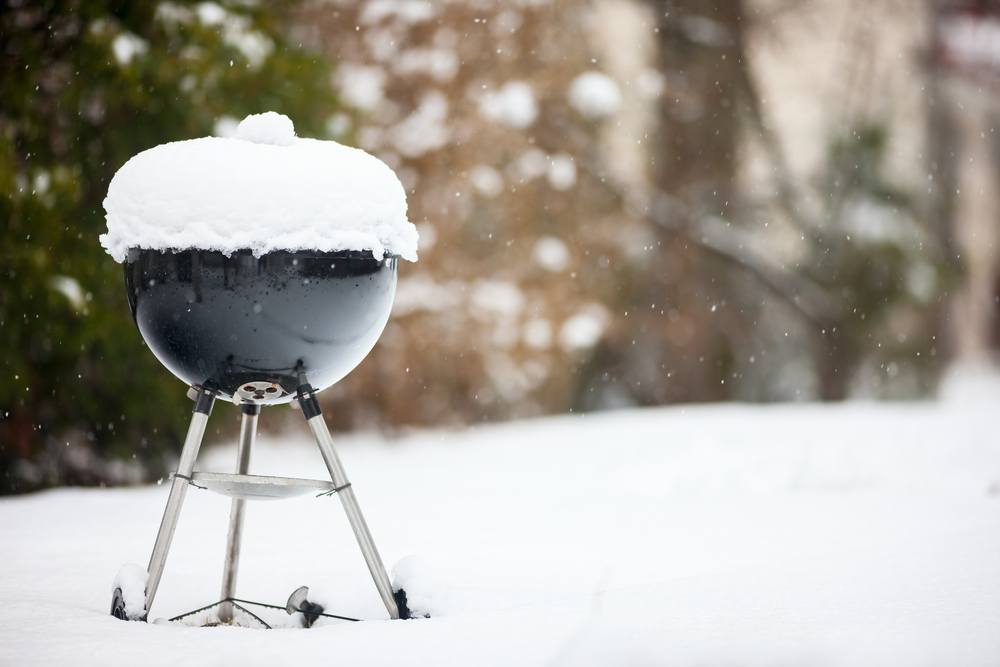 A BBQ with snow on it