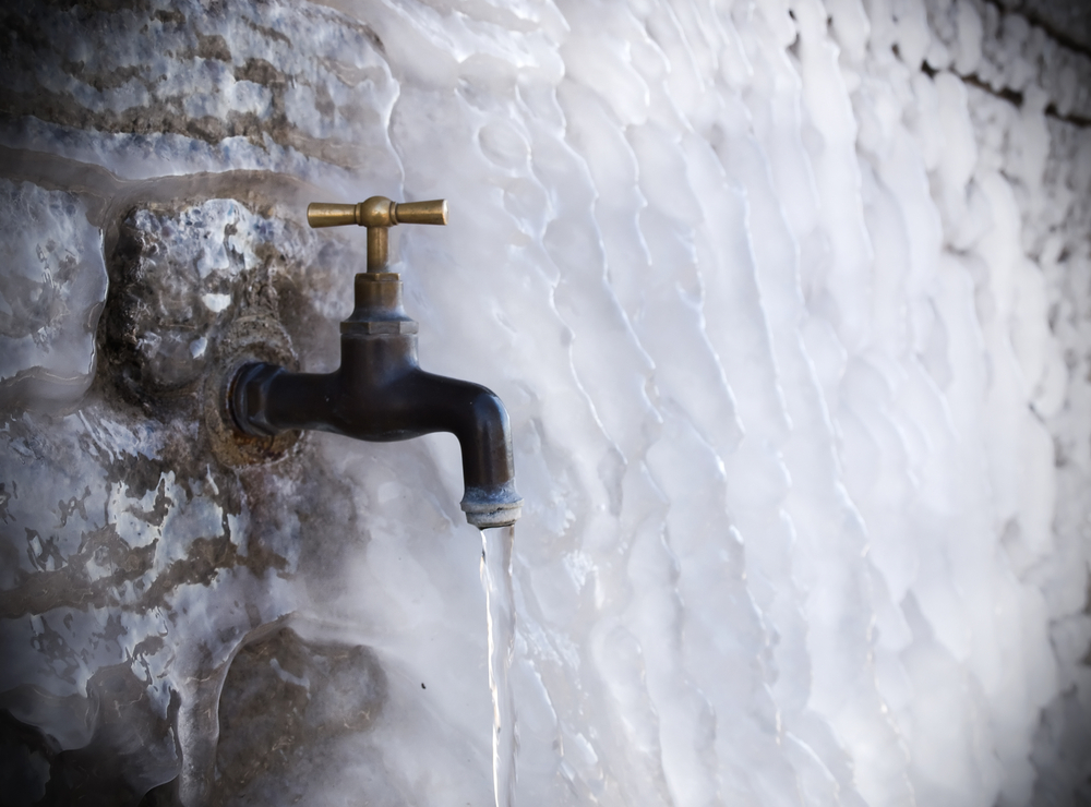 Tap on a frozen wall