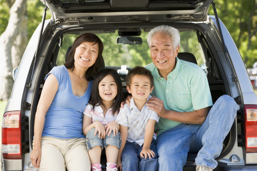 Grandparents with grandkids in tailgate of car
