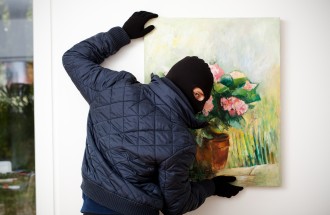 A masked thief stealing a piece of art