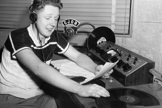 A young Red Robinson in his radio studio.