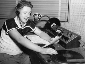 A young Red Robinson in his radio studio.