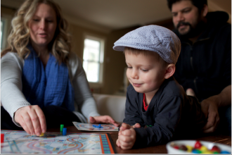 A family playing board games, a close-up of a boy.