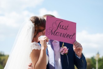 A bride and groom with a Just Married sign.