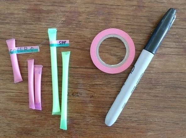 Pixie stick tubes for cream and rolled up tape and permanent marker.
