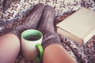 Cozy with book and hot drink and wool socks
